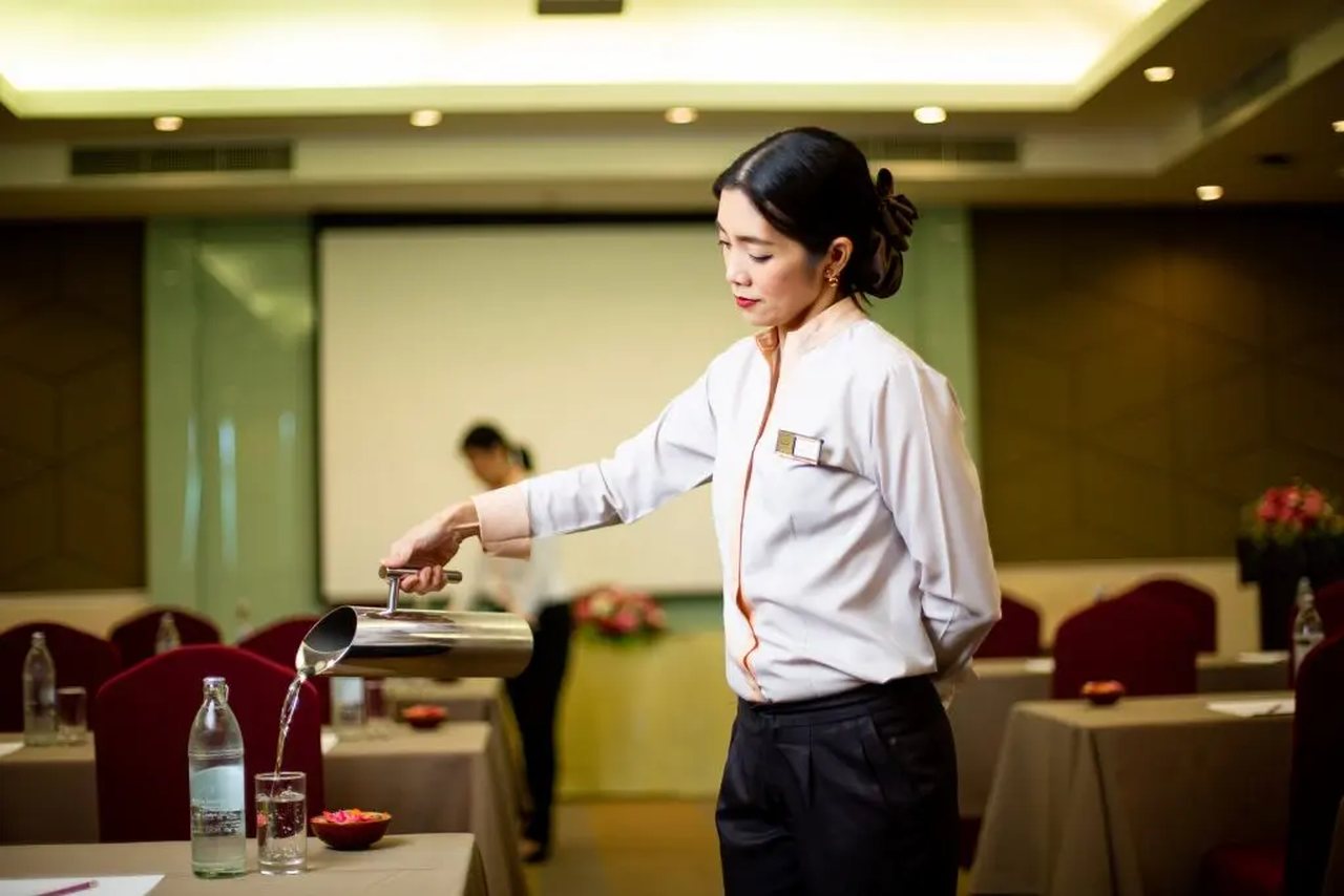 Pattana Resort - Waitress Pouring a Glass of Water